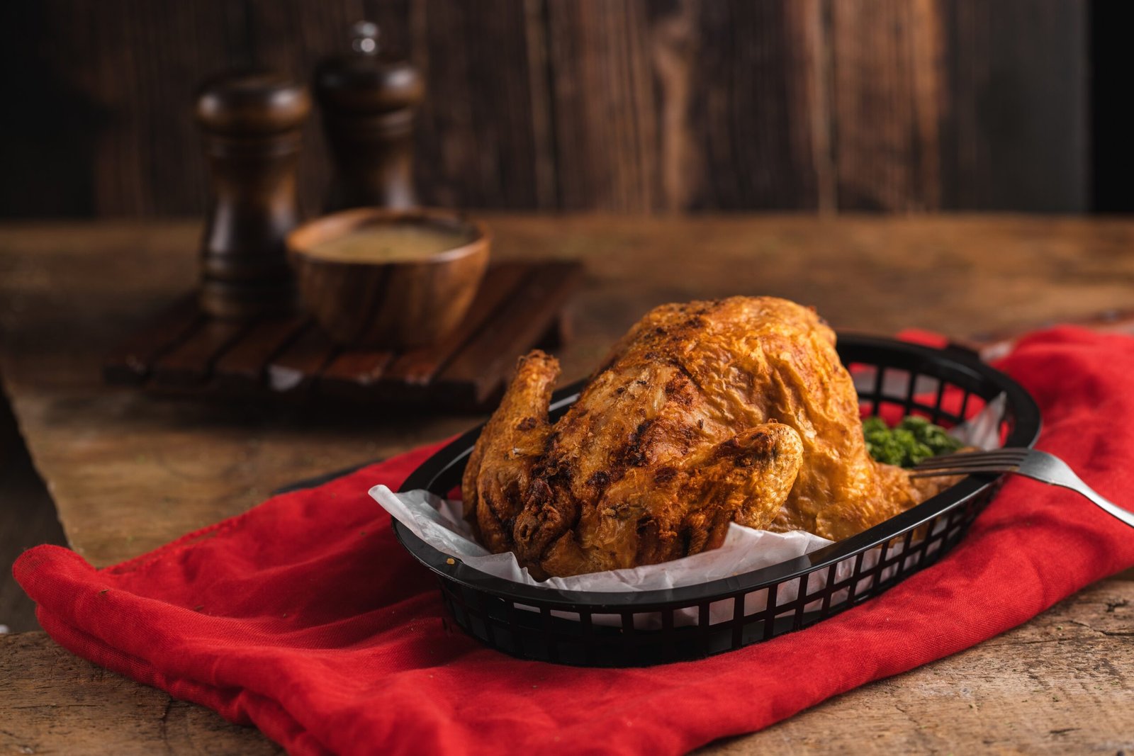 delicious roasted chicken near some spices red tablecloth wooden table scaled